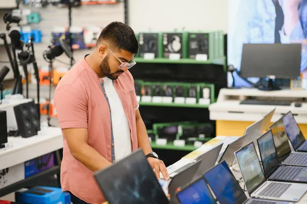 male-buyer-looks-laptops-computer-department-electronics-store_255667-82256