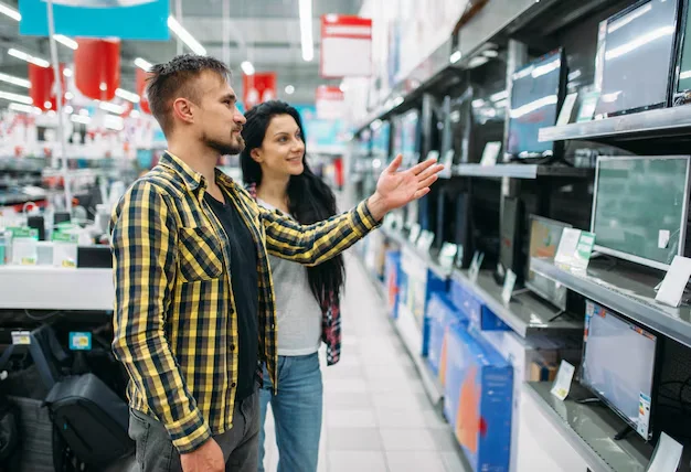 young-couple-buying-monitor-supermarket_266732-6192